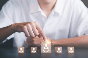 HRM or Human Resource Management ,Strategic planning for success through people business development concept by choosing professional leaders employee competency Teamwork, man pointing at wooden block